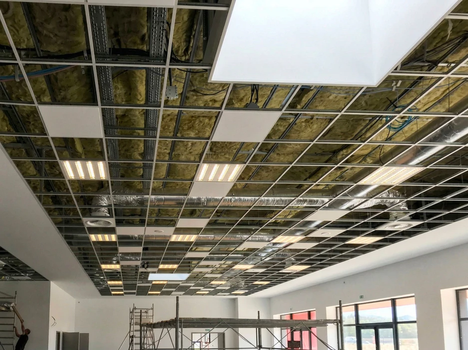 Plafond suspendu en cours d'installation dans un local commercial